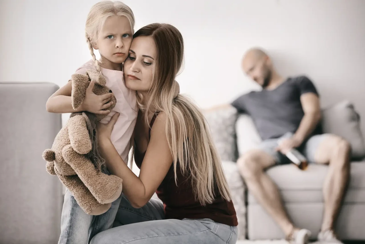 woman-hugging-child-man-on-couch