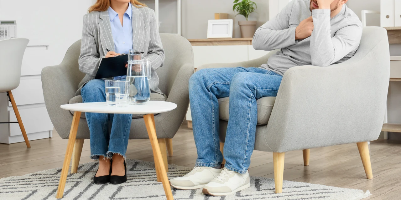 A therapist speaks with someone during a counselling session, showing the professional support and treatment available for drugs addiction recovery.