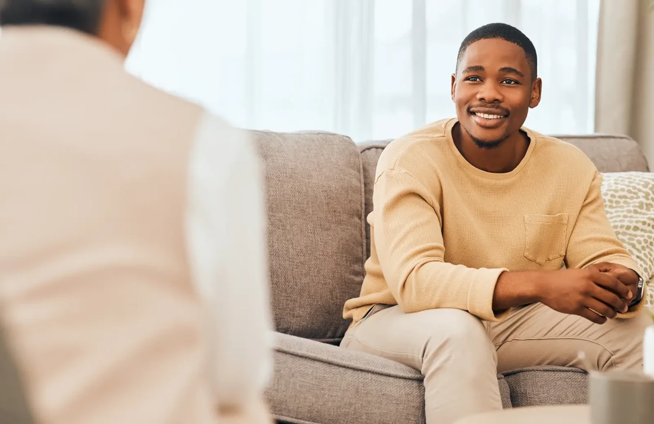 therapy-session-man-smiling-in-camera therapy-session-man-smiling-in-camera