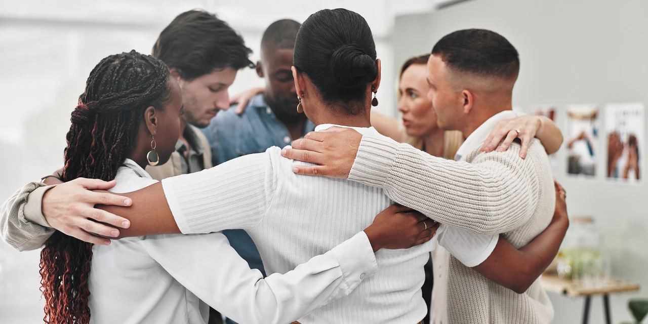 People stand together in a support group during dual diagnosis treatment, reflecting connection, recovery and emotional support throughout the healing process.
