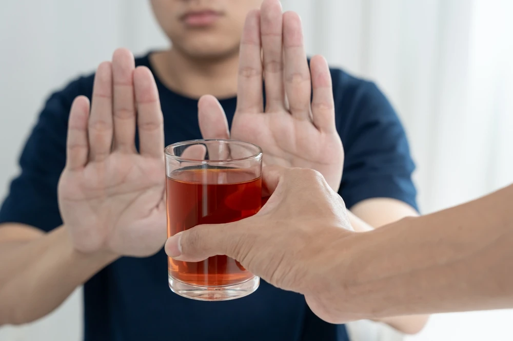 person-refusing-glass-of-alcohol