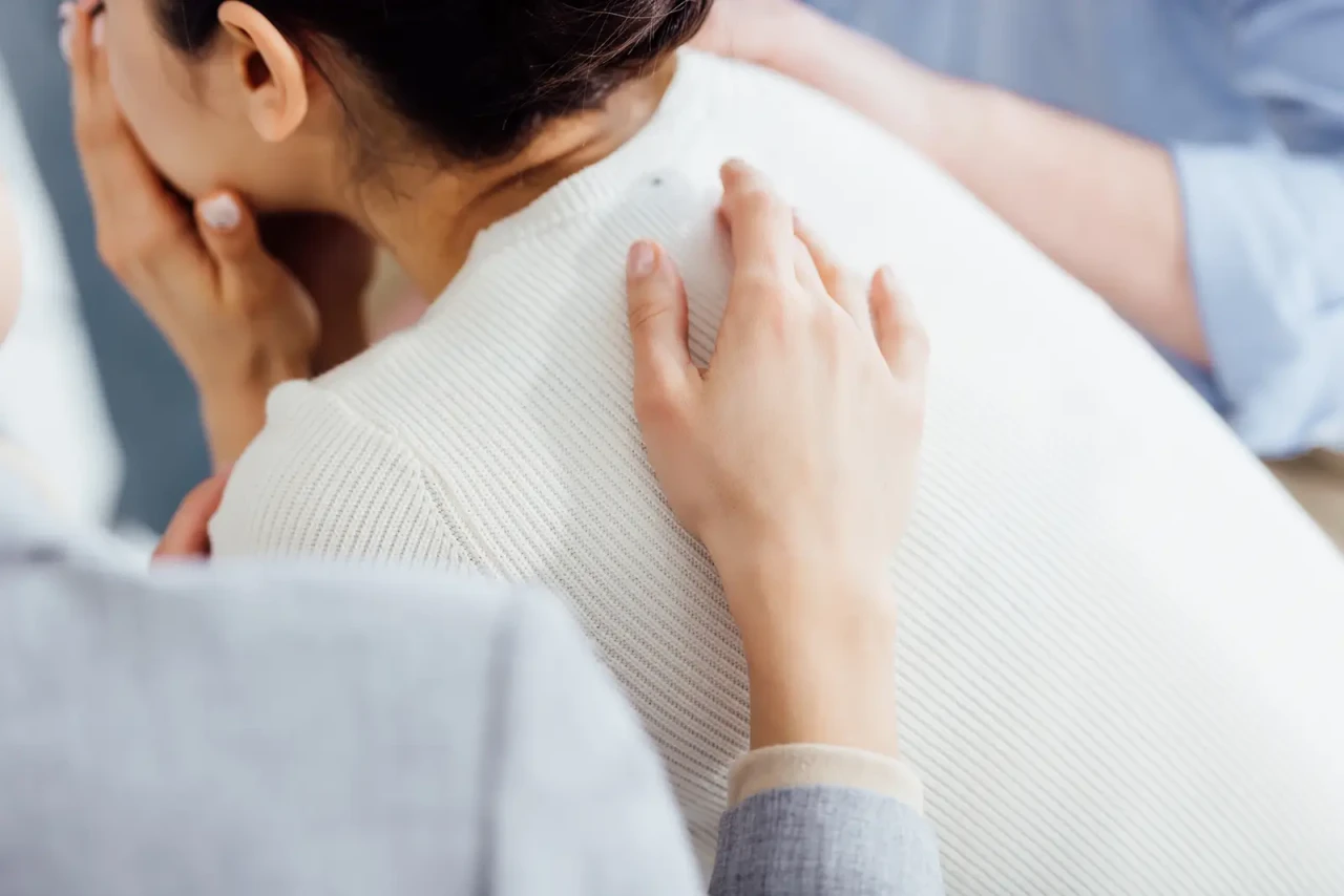 woman-being-comforted-hand-on-back woman-being-comforted-hand-on-back