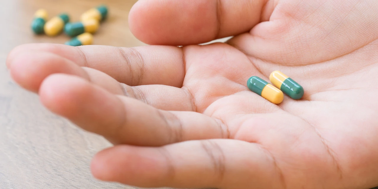 A person holds tramadol capsules in their hand, highlighting prescription medication use and the risks connected to tramadol addiction.