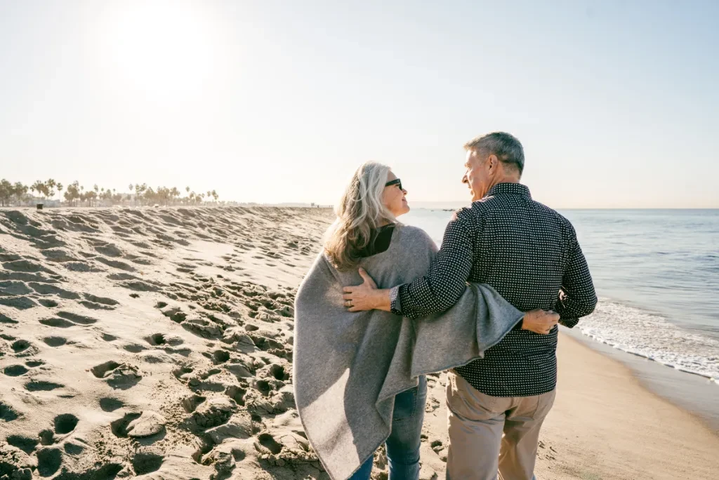 older-couple-walking-on-beach older-couple-walking-on-beach