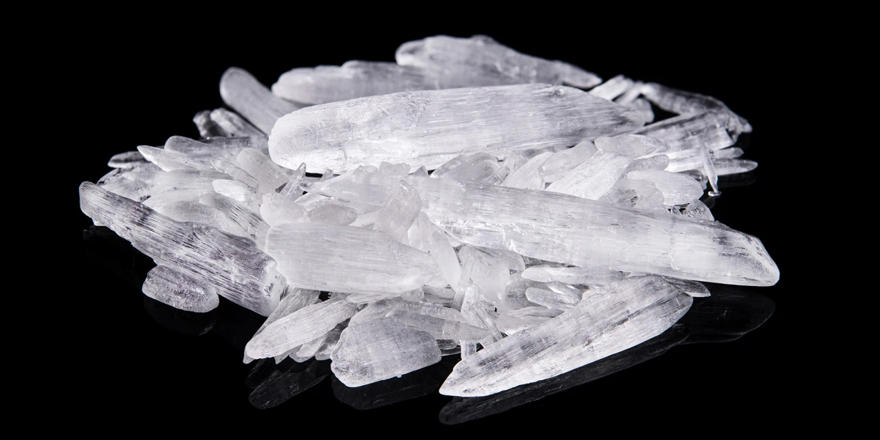 A close-up image of crystal meth crystals on a dark surface, illustrating the dangerous substance linked to crystal meth addiction.